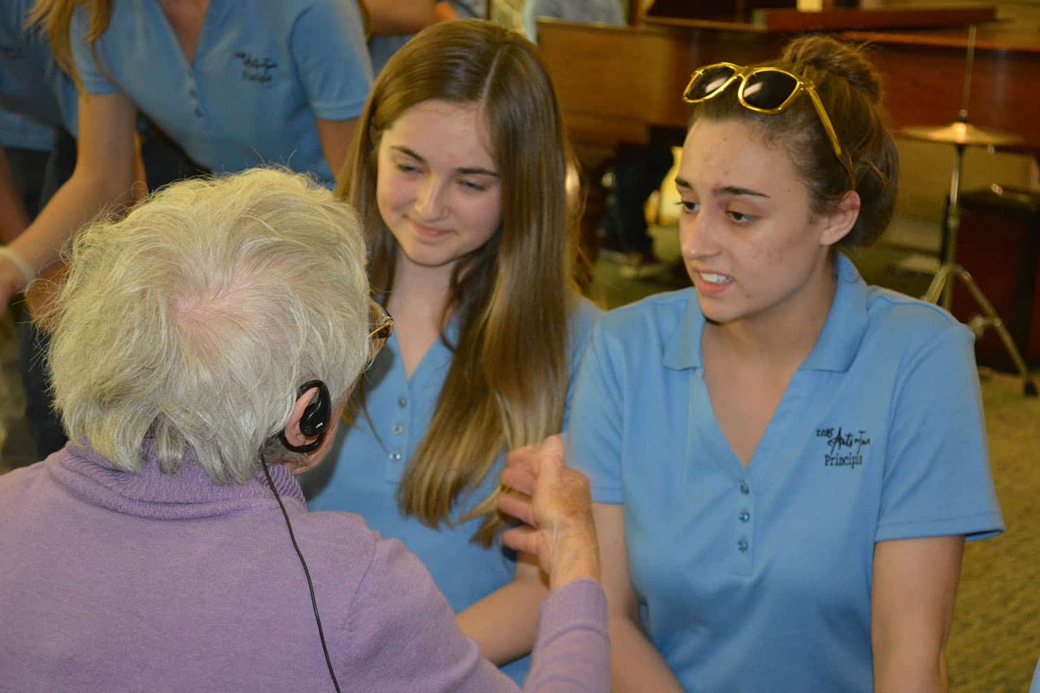Two Arts on Tour members visit with a Broadview guest after the performance.