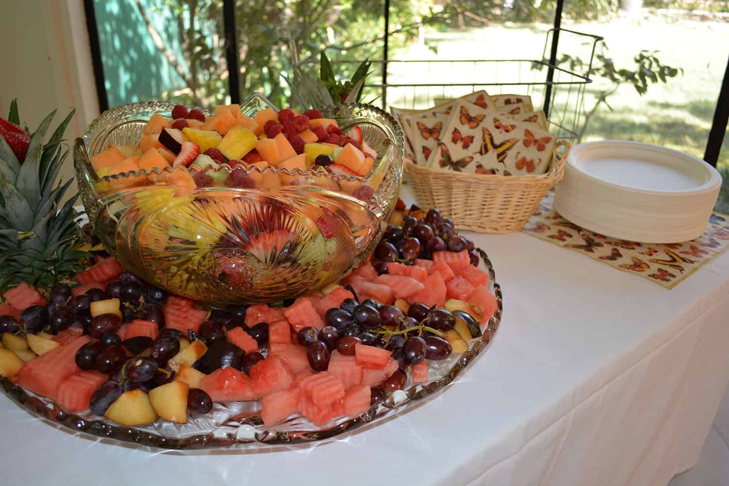A large platter of melon, grapes, berries, and other fresh fruit.